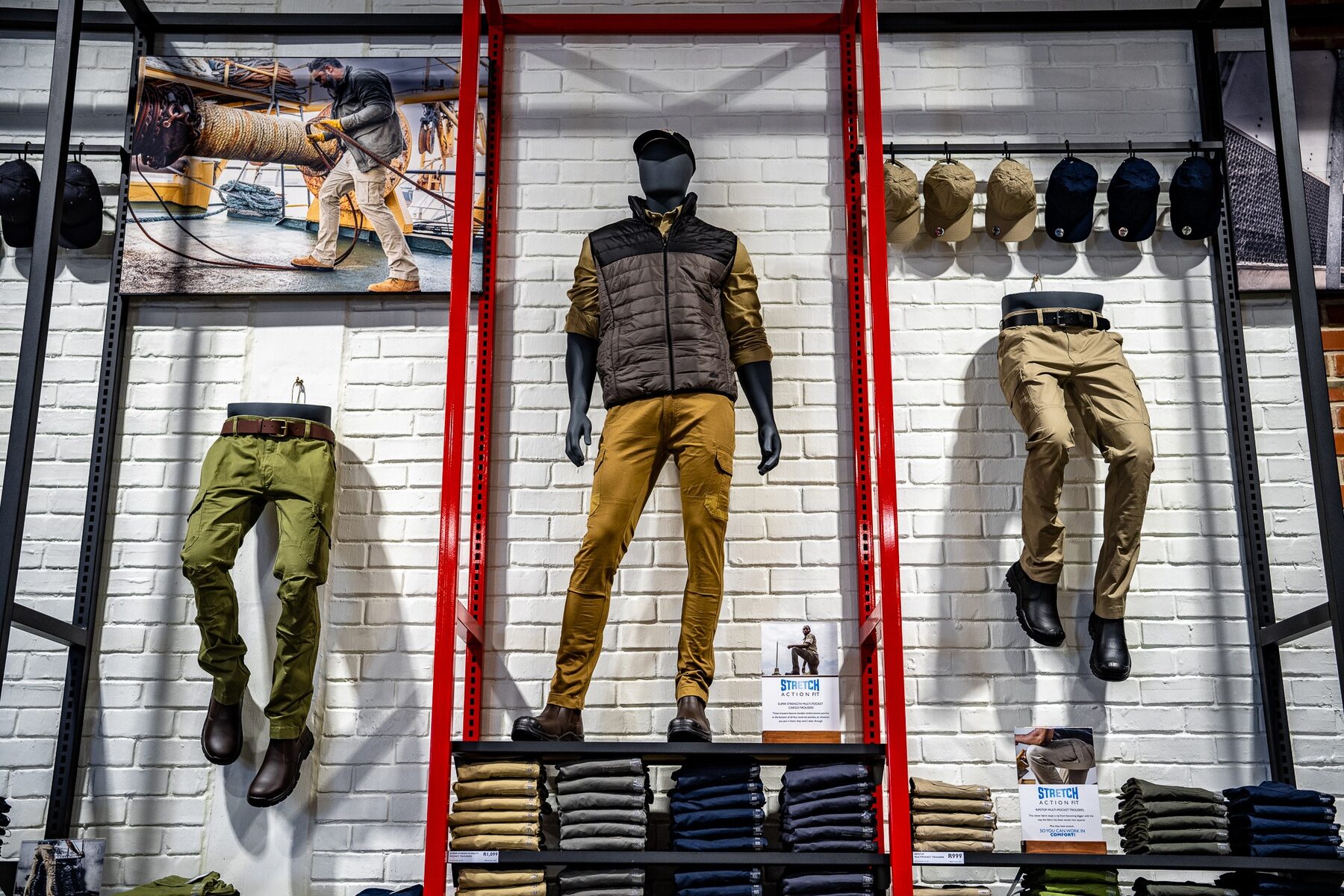 Wall-mounted trouser forms and a male mannequin in a Jonsson Workwear display